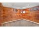 Unfurnished bonus space with knotty pine walls, neutral carpet and a source of natural light at 1380 S Fillmore St, Denver, CO 80210