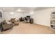 Spacious finished basement with neutral carpeting, two seating areas, and a work from home space at 1380 S Fillmore St, Denver, CO 80210