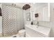 Modern bathroom featuring a stylish sink, updated vanity and sleek shower with patterned curtain at 1380 S Fillmore St, Denver, CO 80210