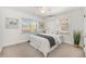 Bright bedroom featuring two windows, artwork, a ceiling fan, and soothing striped bedding at 1380 S Fillmore St, Denver, CO 80210