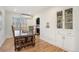 Bright dining room with hardwood floors, a wooden dining table and view into the kitchen at 1380 S Fillmore St, Denver, CO 80210