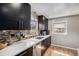 Sleek kitchen with dark cabinets, white countertops, and stainless steel appliances at 1380 S Fillmore St, Denver, CO 80210