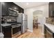 Well-equipped kitchen featuring stainless steel appliances and dark cabinetry at 1380 S Fillmore St, Denver, CO 80210