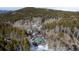 High angle view of cabin nestled into treeline on hillside at 9061 N Rex Ln, Conifer, CO 80433