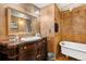 Classic bathroom with a clawfoot tub, unique vanity, and vintage-inspired fixtures at 9061 N Rex Ln, Conifer, CO 80433