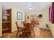 Cozy dining room featuring hardwood floors and an open view into the kitchen at 9061 N Rex Ln, Conifer, CO 80433