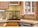Well-lit kitchen features a window with a view, a black sink, and updated tile backsplash at 9061 N Rex Ln, Conifer, CO 80433