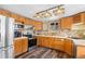 Bright kitchen with wood cabinets, modern appliances, and decorative lighting fixtures at 9061 N Rex Ln, Conifer, CO 80433
