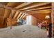 Spacious living room featuring beamed ceilings, plush carpet and comfortable seating, great for relaxing or entertaining guests at 9061 N Rex Ln, Conifer, CO 80433