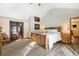 Bright main bedroom boasts vaulted ceiling, natural wood frame, and ample natural light at 9061 N Rex Ln, Conifer, CO 80433