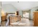 Spacious main bedroom with natural wood bedframe and large sliding door to the outdoors at 9061 N Rex Ln, Conifer, CO 80433