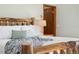Close-up of the main bedroom's bed, showing rustic wood frame and comfortable linens at 9061 N Rex Ln, Conifer, CO 80433