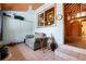Inviting sitting room featuring tile floors, a comfortable chair, and a view into the house at 9061 N Rex Ln, Conifer, CO 80433