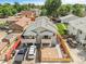 A wide angle aerial shot of the tan two-story home with a gray roof in a well-kept neighborhood at 3470 W Walsh Pl, Denver, CO 80219