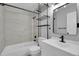 Well-lit bathroom with a tub and shower, modern vanity, and stylish black fixtures at 3470 W Walsh Pl, Denver, CO 80219