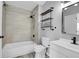 Modern bathroom with gray-tiled shower, updated vanity, and industrial style shelving at 3470 W Walsh Pl, Denver, CO 80219