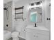 Bright bathroom showcasing a modern vanity, shelving, and shower with updated fixtures at 3470 W Walsh Pl, Denver, CO 80219