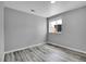 Neutral bedroom featuring gray vinyl flooring, a window, and simple trim at 3470 W Walsh Pl, Denver, CO 80219