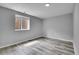 This bedroom provides wood floors and a window at 3470 W Walsh Pl, Denver, CO 80219