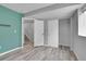 This bedroom features wood floors, a closet with sliding doors, and neutral walls at 3470 W Walsh Pl, Denver, CO 80219