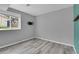 This bedroom offers wood floors, neutral walls, a window, and a TV mount at 3470 W Walsh Pl, Denver, CO 80219