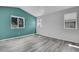 This bedroom boasts wood floors, neutral walls, and multiple windows at 3470 W Walsh Pl, Denver, CO 80219