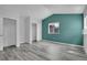 This bedroom offers wood floors, neutral walls, a closet, and a window at 3470 W Walsh Pl, Denver, CO 80219