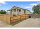 Exterior view showcasing a fenced yard with a home under a blue sky at 3470 W Walsh Pl, Denver, CO 80219