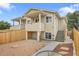 Exterior view of a two-story home, with a fenced yard and gravel landscaping at 3470 W Walsh Pl, Denver, CO 80219