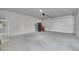Spacious garage interior with a concrete floor and a white overhead door at 3470 W Walsh Pl, Denver, CO 80219