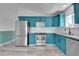Spacious kitchen with blue cabinets, stainless steel appliances, and light gray wood-look flooring at 3470 W Walsh Pl, Denver, CO 80219