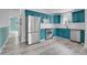 Bright kitchen featuring blue cabinets, stainless steel appliances, and sleek subway tile backsplash at 3470 W Walsh Pl, Denver, CO 80219