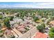 Scenic aerial view capturing a quiet residential neighborhood with mature trees and mountain views at 3470 W Walsh Pl, Denver, CO 80219
