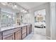 Beautiful bathroom with a dual sink vanity and large mirror with views into the bedroom at 10887 Endeavor Dr, Parker, CO 80134