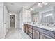 Large bathroom with a dual sink vanity and tiled glass shower at 10887 Endeavor Dr, Parker, CO 80134