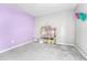 Bright bedroom featuring two-toned walls with a dollhouse ready for imaginative play at 10887 Endeavor Dr, Parker, CO 80134