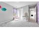 A cozy bedroom nook with a window, pink pillows, and a vanity with an oval mirror at 10887 Endeavor Dr, Parker, CO 80134