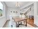 Elegant dining room featuring a wooden table and upholstered chairs, with view of staircase at 10887 Endeavor Dr, Parker, CO 80134