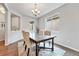Cozy dining room with a wooden table, upholstered chairs, and natural light at 10887 Endeavor Dr, Parker, CO 80134