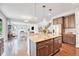 A kitchen and living room view featuring an island with granite countertops and a stainless steel refrigerator at 10887 Endeavor Dr, Parker, CO 80134