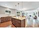 An open concept kitchen featuring a granite countertop island with view into the living room at 10887 Endeavor Dr, Parker, CO 80134