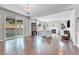Bright living room with fireplace, large windows, hardwood floors, and sliding glass doors to the backyard at 10887 Endeavor Dr, Parker, CO 80134
