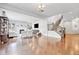 Spacious living room with a fireplace, hardwood floors, and elegant staircase at 10887 Endeavor Dr, Parker, CO 80134