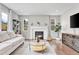 Bright living room with fireplace, modern furniture, and hardwood floors at 10887 Endeavor Dr, Parker, CO 80134