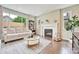 Cozy living room featuring a fireplace, large window, and modern decor at 10887 Endeavor Dr, Parker, CO 80134