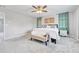 Cozy main bedroom featuring gray carpet, soft bench, and decorative wall art at 10887 Endeavor Dr, Parker, CO 80134