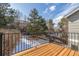 Outdoor deck overlooking a tree-filled backyard and a sky with patchy clouds at 364 Willowick Cir, Highlands Ranch, CO 80129