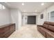 Spacious finished basement with modern flooring, a sofa, and a stylish Murphy bed at 364 Willowick Cir, Highlands Ranch, CO 80129