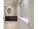 Elegant bathroom featuring stone backsplash wall, modern vanity and fixtures, and frosted window at 364 Willowick Cir, Highlands Ranch, CO 80129