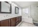 Bathroom featuring double vanity, soaking tub, glass enclosed shower, and decorative tile accents at 364 Willowick Cir, Highlands Ranch, CO 80129